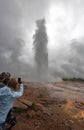 People recording the Great Geysir eruption in Southwestern Iceland